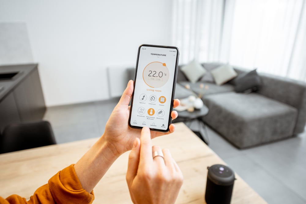a closeup of a person using their iphone to control their smarthome