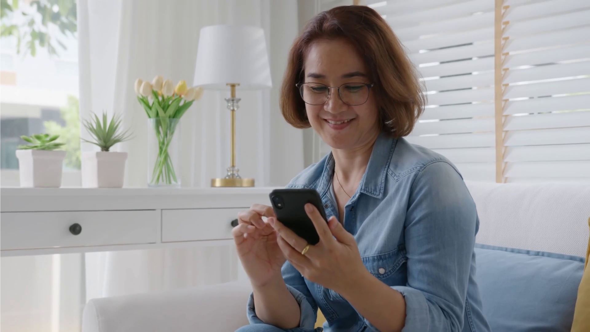woman smiling at phone woman smiling at phone